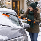Orange DR101-1 snow brush sweeping loose snow from a parked car windscreen