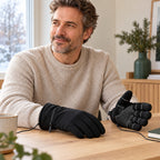 Middle-aged man wearing black JRST01 wired USB heated gloves at a quiet winter desk