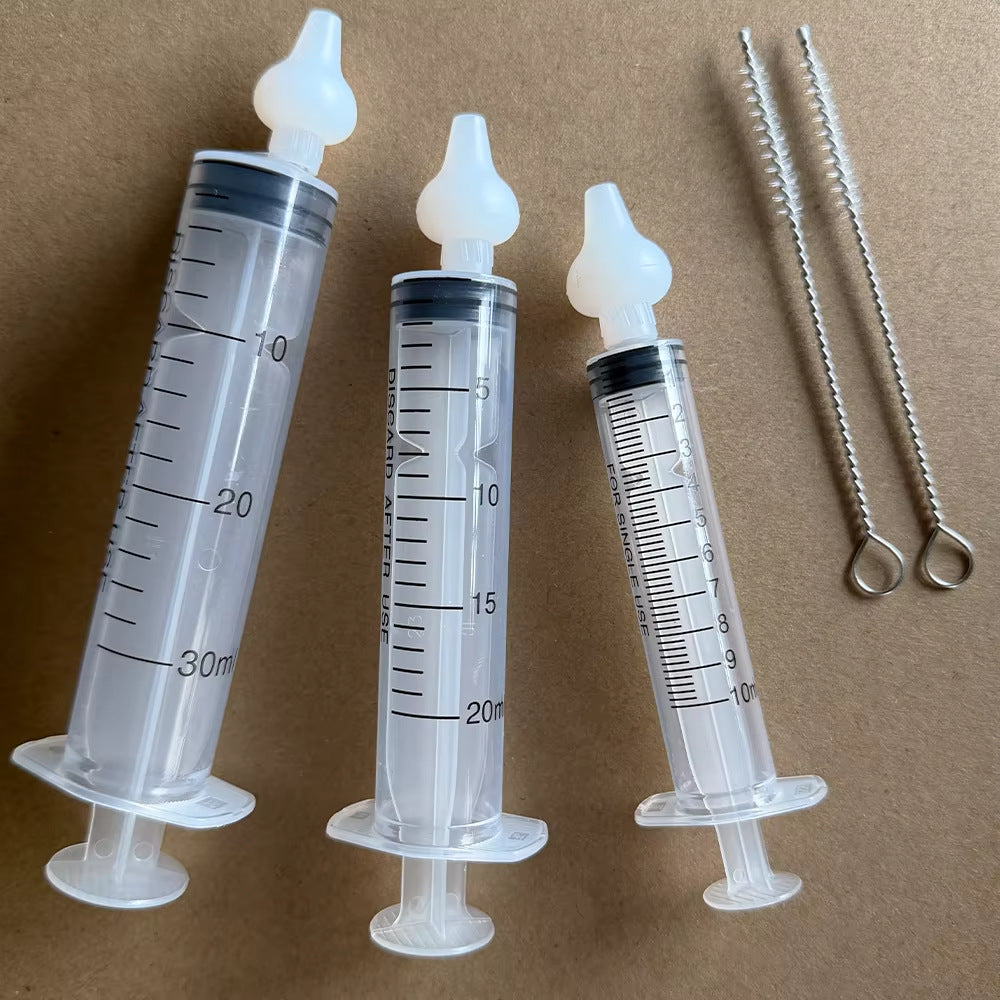 Three graduated manual syringes with detachable soft tips and two cleaning brushes